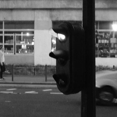 Traffic light at night, car passing